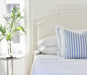 cobalt blue striped luxury bed linens on bed with corn flower blue striped pillow