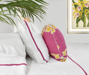luxury bed linens with orchid pin stripe on bed with throw pillow and antique botanical fine art print on wall