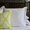 lime green lilly pulitzer shell we pattern throw pillow on bed with headboard and bed linens